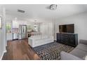 Open-concept living room featuring modern decor, hardwood floors, and seamless flow to the kitchen at 6090 Heritage Se Way, Mableton, GA 30126