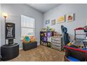 Well-lit bedroom with plush carpet, showcasing a cozy window, playful decor, and ample shelving for storage at 881 Ash St, Canton, GA 30114