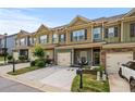 Beautiful townhome with a one-car garage and a welcoming front yard, creating a pleasant and inviting entrance at 881 Ash St, Canton, GA 30114