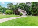Suburban two-story house with a long driveway and large, well-manicured lawn at 1205 Rivershyre Ne Pkwy, Lawrenceville, GA 30043