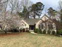 Inviting single-story home with a well-manicured lawn and mature flowering trees in a lovely setting at 1205 Rivershyre Ne Pkwy, Lawrenceville, GA 30043