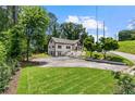 Expansive lawn highlights this lovely two-story home, featuring a balcony and mature trees, set back from the road at 1887 Shalimar Dr, Atlanta, GA 30345