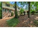 Two story home with a lush green lawn, mature trees, and brick accents at 3802 Sw Knights Bridge Sw Rd, Lilburn, GA 30047
