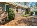 Lovely home features a brick front and attached garage nestled in a wooded area at 3802 Sw Knights Bridge Sw Rd, Lilburn, GA 30047