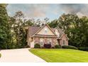 Well-maintained home featuring a stone facade and a long driveway at 200 Scouts Ridge Dr, Covington, GA 30016