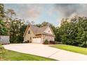 Home with large paved driveway and an attached two-car garage at 200 Scouts Ridge Dr, Covington, GA 30016