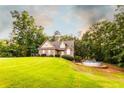 Expansive lawn complements this home with its above-ground pool and mature trees at 200 Scouts Ridge Dr, Covington, GA 30016