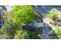 An aerial view shows a home nicely landscaped with mature trees in a quiet residential neighborhood at 251 Waterford Cove Dr, Suwanee, GA 30024