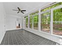 Bright sunroom with tiled floor and large windows overlooking the lush greenery at 2935 Leafwood Se Dr, Marietta, GA 30067