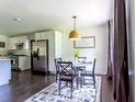 Cozy dining area with modern table and chairs adjacent to a well-equipped kitchen at 6715 Wright Rd, Sandy Springs, GA 30328