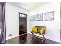 Inviting entryway featuring a dark wood door, a wooden bench with bright yellow pillows at 6715 Wright Rd, Sandy Springs, GA 30328