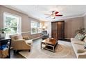 Cozy living room with neutral tones, large windows, and comfortable seating area at 4031 E Meadow Dr, Duluth, GA 30096