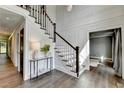 Elegant foyer with hardwood floors, a staircase, detailed millwork and stylish lighting at 1168 Atcheson Ln, Atlanta, GA 30338