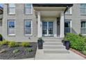 Charming front porch with a painted brick façade, double doors, and manicured landscaping at 1168 Atcheson Ln, Atlanta, GA 30338
