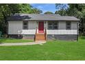 Charming home with a freshly painted exterior and a vibrant red front door, set on a well-manicured lawn at 1202 Key Se Rd, Atlanta, GA 30316