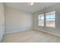 Bright, empty bedroom with hardwood floors and large windows offering plenty of natural light at 2485 Dixon Pl, Lawrenceville, GA 30045