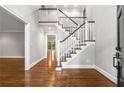 A grand foyer with hardwood floors and a staircase with decorative railings at 355 Highlands Trce, Roswell, GA 30075