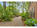 A peaceful stone patio next to the brick house and beautiful landscaping perfect for outdoor relaxation at 355 Highlands Trce, Roswell, GA 30075