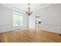 Open dining room with hardwood floors, natural light and access to kitchen, ideal for entertaining at 576 Cliftwood Ct, Sandy Springs, GA 30328