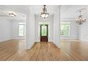 Bright foyer with wood floors and a decorative glass front door, open to living space at 576 Cliftwood Ct, Sandy Springs, GA 30328