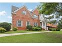 Beautiful brick home featuring a lush front yard and well-maintained landscaping at 112 Tara Blvd, Loganville, GA 30052