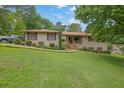 Beautiful brick ranch home with manicured lawn and landscaping; pickup truck parked in driveway at 2149 New London Place Pl, Snellville, GA 30078