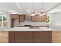 Gourmet kitchen featuring a marble countertop island, custom cabinetry, and modern appliances at 327 Ohm Ave, Avondale Estates, GA 30002