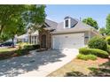 Beautiful home features stone accents, manicured landscaping, and a spacious two-car garage at 6350 Manningtree Ct, Cumming, GA 30041