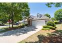 Attractive home featuring stone accents, neat landscaping, and a convenient two-car garage at 6350 Manningtree Ct, Cumming, GA 30041