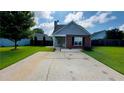 Single-story home with a well-kept lawn, a covered entryway and a mix of brick and siding at 1972 Brittania Cir, Woodstock, GA 30188