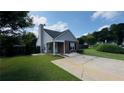 Charming home with a neatly maintained lawn and a covered entryway, enhanced by lush landscaping at 1972 Brittania Cir, Woodstock, GA 30188
