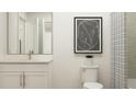Contemporary bathroom showcases a shower with a patterned curtain, white vanity, and modern art at 2288 Linden Pass, Douglasville, GA 30135