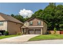 Inviting two-story home with brick accents, a two-car garage, and a beautifully landscaped yard at 2521 Livingston Ct, Loganville, GA 30052