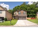 Attractive two-story home featuring brick detailing, a two-car garage, and a well-manicured lawn at 2521 Livingston Ct, Loganville, GA 30052