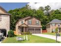 Beautiful two-story home boasting a brick front, two-car garage, and lush greenery at 2521 Livingston Ct, Loganville, GA 30052