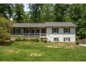 Charming split-level home featuring a landscaped front yard and a cozy front porch at 2795 Bentwood Dr, Marietta, GA 30062