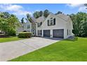Charming home featuring an attached two-car garage and a lush green lawn at 5706 Brookstone Nw Walk, Acworth, GA 30101