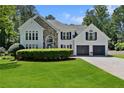 Beautiful home with a stone accent, two-car garage, well-manicured lawn, and tasteful landscaping at 5706 Brookstone Nw Walk, Acworth, GA 30101