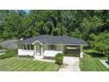 Charming single-story home with a well-manicured lawn and attached carport at 805 Gertrude Nw Pl, Atlanta, GA 30318