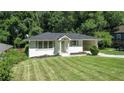 Charming single-story home with a well-manicured lawn and attached carport at 805 Gertrude Nw Pl, Atlanta, GA 30318