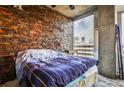 Stylish bedroom with a stone accent wall, large windows, and modern furnishings at 860 Peachtree Street Northeast Ne St # 811, Atlanta, GA 30308