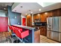 Modern kitchen with stainless steel appliances, granite countertops, and a breakfast bar with red chairs at 860 Peachtree Street Northeast Ne St # 811, Atlanta, GA 30308