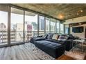Inviting living room featuring a comfy couch, city views, and a sliding glass door to a small balcony at 860 Peachtree Street Northeast Ne St # 811, Atlanta, GA 30308