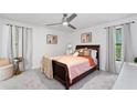 Comfortable bedroom featuring soft carpet, a ceiling fan, and great windows for natural light at 4771 N Springs Nw Rd, Kennesaw, GA 30144