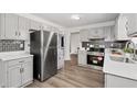 Well-lit kitchen featuring stainless steel appliances, white cabinets, and subway tile backsplash at 4771 N Springs Nw Rd, Kennesaw, GA 30144