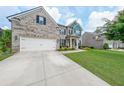 Charming two-story home with a large driveway and a two car garage at 5789 Creek Indian Dr, Sugar Hill, GA 30518