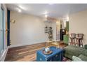 Cozy living room featuring hardwood floors, shelving, and an open-concept design with a kitchen view at 1195 Milton Se Ter # 2203, Atlanta, GA 30315