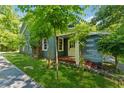 Blue cottage-style house with a stone walkway and lush landscaping, exuding charm at 13795 Arnold Mill Rd, Roswell, GA 30075