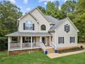Beautiful two-story home featuring a welcoming front porch and well-maintained lawn at 25 Grange Ct, Sharpsburg, GA 30277