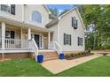 Inviting front porch with stylish blue planters, leading to the home's entrance at 25 Grange Ct, Sharpsburg, GA 30277